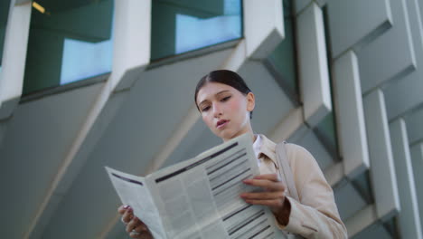 Woman-reading-newspaper-street-closeup.-Business-lady-deploying-periodical-press