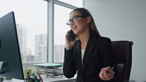 Sales-agent-talking-phone-consulting-client-closeup.-Smiling-woman-work-office