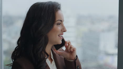Entrepreneur-smiling-speaking-telephone-at-office-window-closeup.-Lady-satisfied