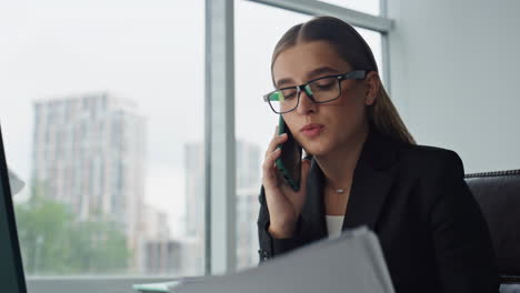 Concerned-businesswoman-speaking-mobile-phone-closeup.-Office-manager-working