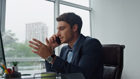 Focused-worker-talking-mobile-phone-closeup.-Handsome-sales-man-speaking-client