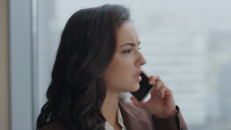 Office-manager-chatting-phone-standing-at-window-closeup.-Woman-using-telephone.