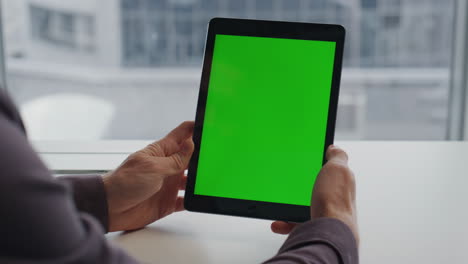Man-hands-holding-tablet-chromakey-city-view-table.-Student-reading-mockup-pad
