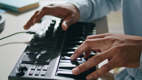 Closeup-equalizer-keyboard-man-hands-touching-at-home-closeup.-Dj-arms-mixing