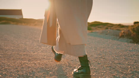 Girl-legs-walking-road-in-sunlight-closeup.-Relaxed-woman-enjoy-autumn-evening