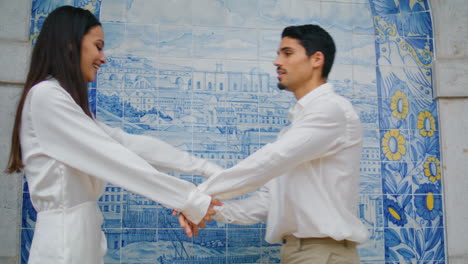 Passionate-couple-dancing-at-azulejo-place-closeup.-Pair-holding-hands-embracing