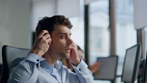 Call-operator-hand-taking-headset-closeup.-Support-professional-talking-customer