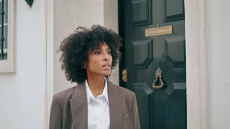Business-woman-leaving-house-closing-door-closeup.-Lady-going-outdoors-in-suit.