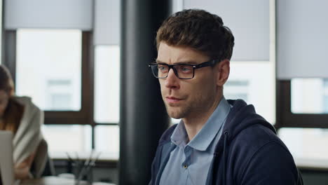 Pensive-entrepreneur-looking-computer-at-office-closeup.-Stressed-man-developer