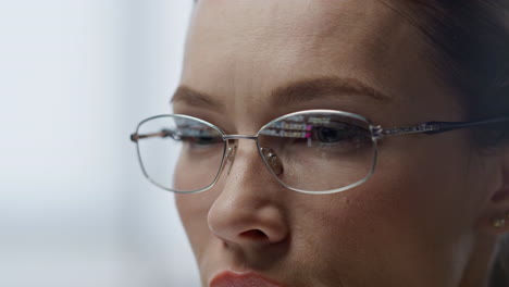 Data-code-reflecting-glasses-closeup.-Software-engineer-woman-programming-work