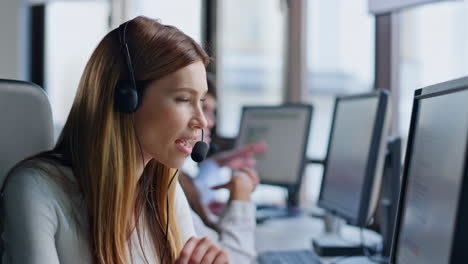 Call-operator-looking-computer-screen-in-office.-Smiling-saleswoman-manager