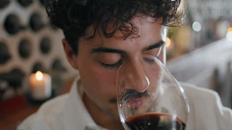 Closeup-sommelier-sniffing-wine-from-glass.-Winery-expert-tasting-smell-vertical