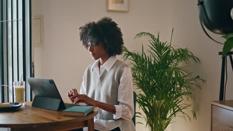 Woman-writer-typing-laptop-sitting-cafe-close-up.-African-girl-working-computer