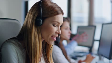 Helpful-woman-working-contact-center-closeup.-Smiling-assistant-talking-headset
