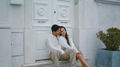Two-lovers-sitting-street-at-evening.-Latina-tender-pair-bonding-lovely-resting