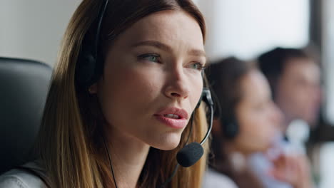 Closeup-friendly-operator-consulting-client-in-headset.-Confident-woman-manager