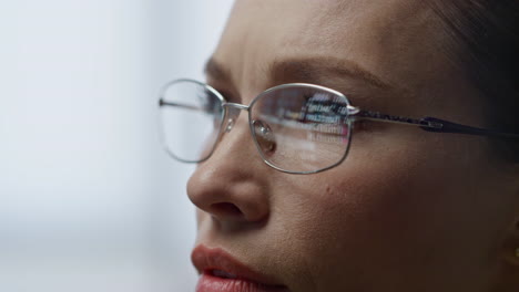 Woman-eyeglasses-reflecting-code-closeup.-Focused-developer-operator-talking