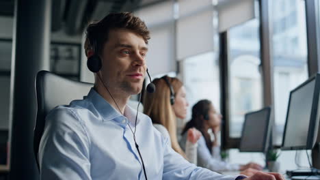 Call-center-operator-talking-headset-in-data-office.-Friendly-man-representative