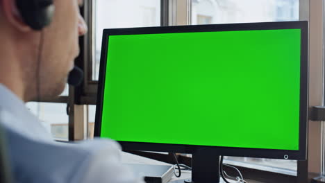 Call-center-green-computer-screen-closeup.-Man-service-operator-talking-customer