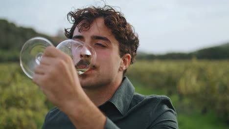 Sommelier-tasting-wine-vineyard-close-up.-Man-winemaker-enjoying-taste-alcohol.