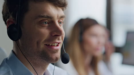 Friendly-agent-speaking-client-in-headset-closeup.-Positive-man-specialist-work