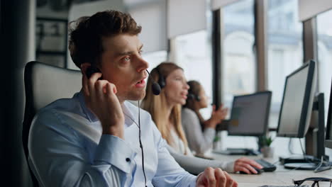 Call-operator-listening-client-in-office.-Friendly-helpline-team-work-together.