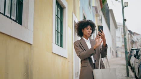 Girl-making-photo-street-on-smartphone-walking-outdoors.-Woman-holding-phone.