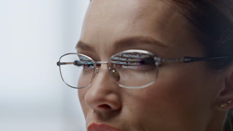 Developer-glasses-reflecting-code-lines-closeup.-Woman-hacker-programming-app