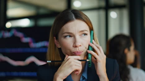 Investment-manager-talking-smartphone-closeup.-Pensive-businesswoman-consulting