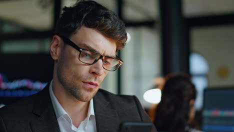 Thoughtful-businessman-working-late-closeup.-Successful-stock-trader-analysing