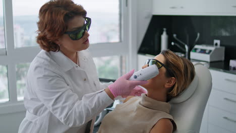 Woman-lying-rejuvenation-laser-procedure-at-modern-cosmetology-clinic-close-up.