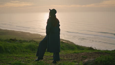 Silhouette-woman-standing-sunset-on-seashore.-Elegant-girl-posing-on-nature.