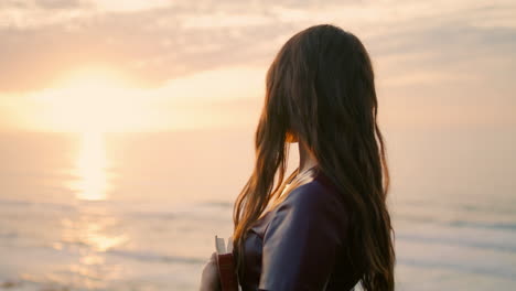 Portrait-romantic-woman-sunset-sky.-Model-posing-near-ocean-with-book-close-up.