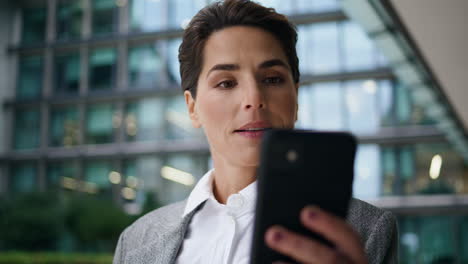 Smiling-manager-making-selfie-using-smartphone-closeup.-Corporate-woman-resting