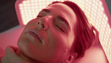 Woman-relaxing-led-light-on-photodynamic-procedure-close-up.-Client-phototherapy