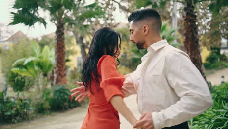 Young-professionals-dancing-energetic-in-park.-Couple-dancers-enjoy-latino-dance