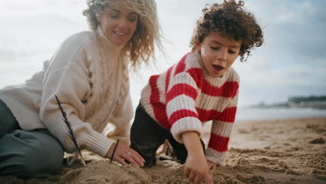 Mutter-Und-Kind-Bauen-Sandfiguren-Am-Meeresstrand.-Glückliches,-Entspanntes-Wochenende-Mit-Der-Familie
