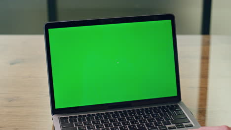 Lady-using-greenscreen-laptop-office-close-up.-Anonymous-business-woman-working