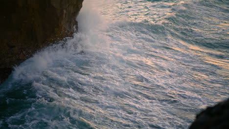Ocean-splashing-cliffside-nature-at-morning-closeup.-Waves-crash-volcanic-rocks