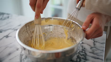 Baby-woman-hands-mixing-ingredients-bowl-indoors-closeup.-Unknown-family-cooking