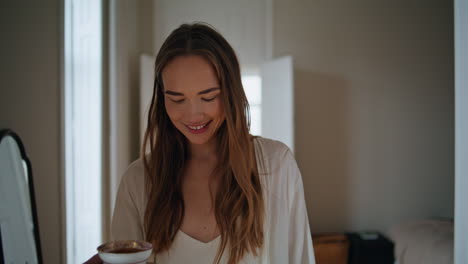 Smiling-lady-walking-morning-interior-closeup.-Relaxed-girl-holding-coffee-cup