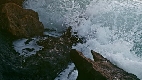 Sea-splashing-crag-nature-at-morning-closeup.-Foamy-water-breaking-over-coast