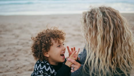 Joyful-mom-kid-playing-on-beach-weekend-closeup.-Happy-parent-spending-quality