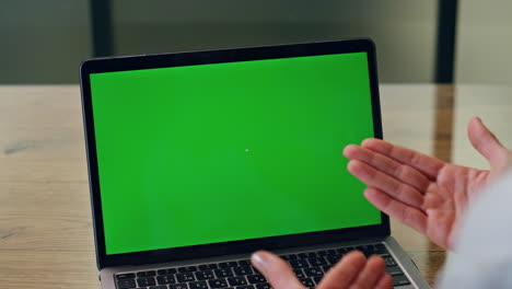 Lady-hands-videocalling-chromakey-computer-at-table-closeup.-Director-video-call