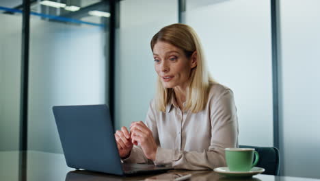 Happy-executive-video-chatting-laptop-workplace-closeup.-Business-woman-talking