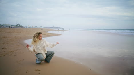 Woman-throwing-stones-water-ocean-on-cloudy-day.-Thinking-girl-resting-seaside