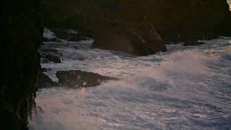 Splashing-water-crashing-rocks-at-dusk-nature-closeup.-Aqua-washing-ocean-hill