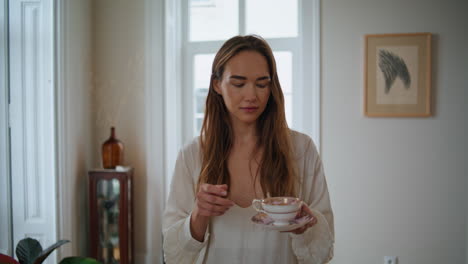 Relaxed-girl-walking-at-morning-closeup.-Calm-woman-sipping-coffee-crossing-home
