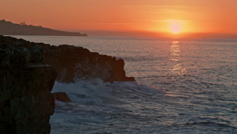 Warm-sunrise-cliffside-nature.-Mountain-hill-silhouette-at-morning-sea-beach