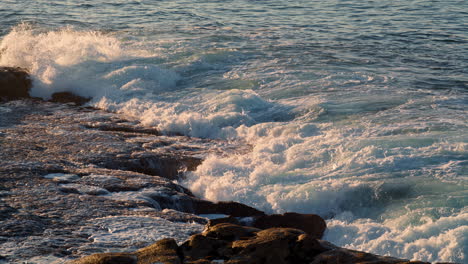 Foamy-sea-waves-streaming-sunbeams-nature-closeup.-Scenic-ocean-water-breaking